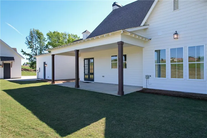This newly constructed home features a spacious covered patio, perfect for outdoor living.