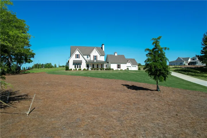 This charming home features a classic exterior and lush green lawn, perfect for outdoor enjoyment.