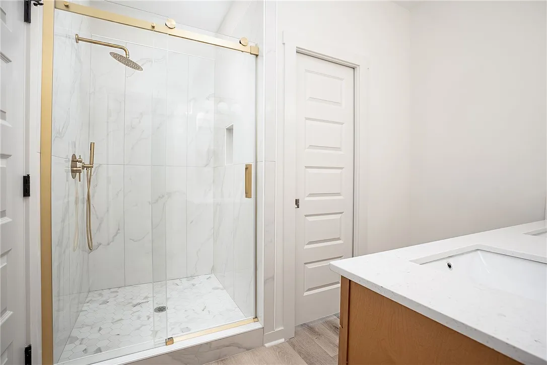 Elegant marble-patterned tile enhances the walk-in shower of this modern bathroom.