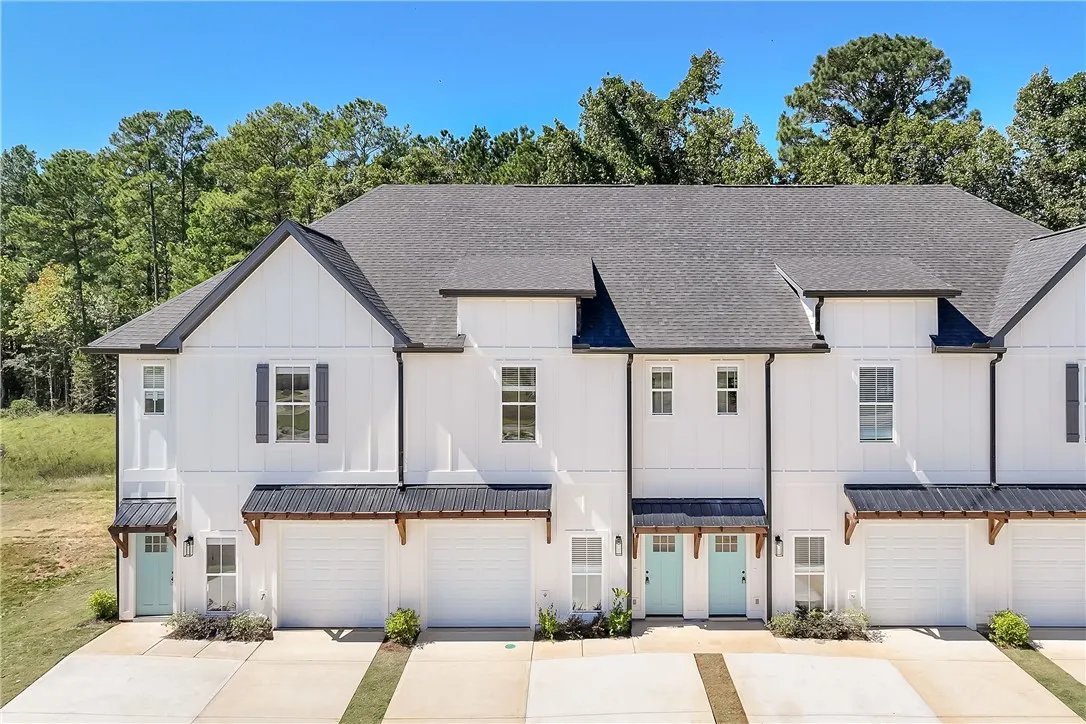 Crisp vertical siding paired with dark roofing creates an appealing exterior architectural profile.