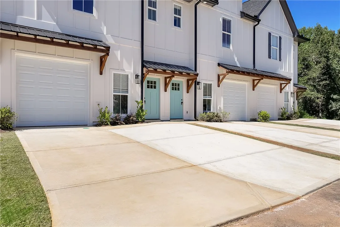 Board and batten siding pairs beautifully with clean concrete driveways and wood-accented entries.