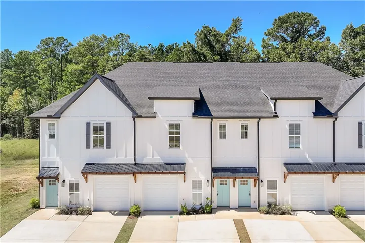Crisp vertical siding paired with dark roofing creates an appealing exterior architectural profile.
