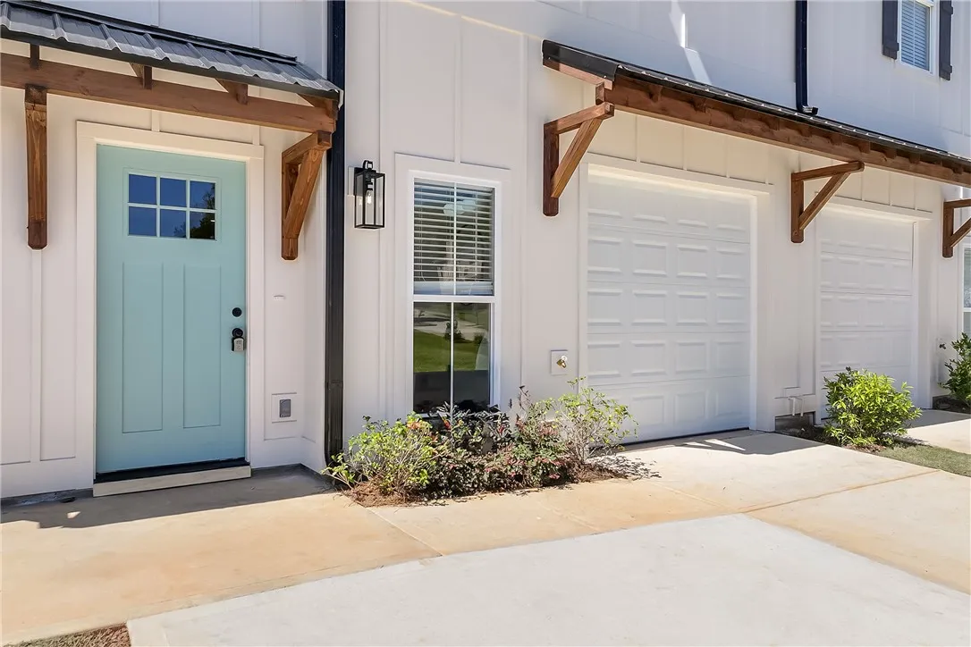 Sharp board and batten siding frames the inviting entry porch and single-car garage.