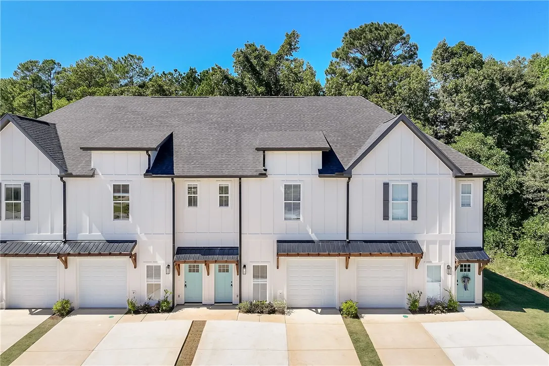 Crisp board and batten siding pairs beautifully with contrasting roofs on this modern multi-family exterior.