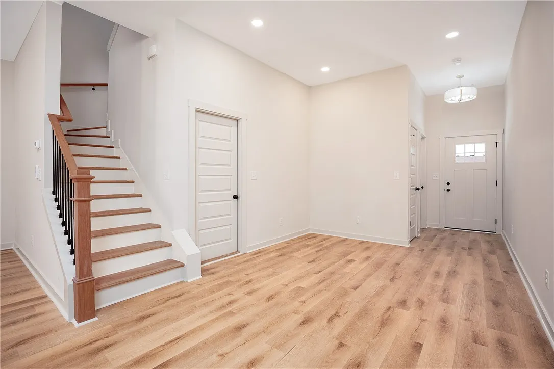A welcoming entryway showcases handsome wood flooring and a classic staircase.