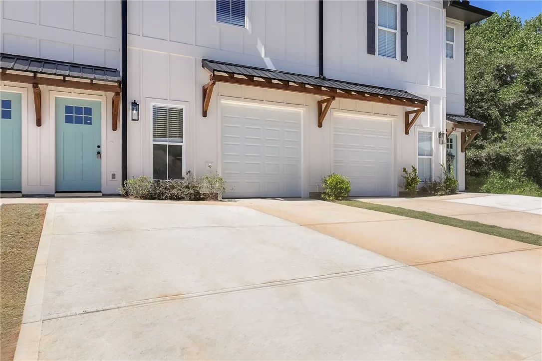 Board and batten siding pairs with metal awnings for modern architectural appeal.