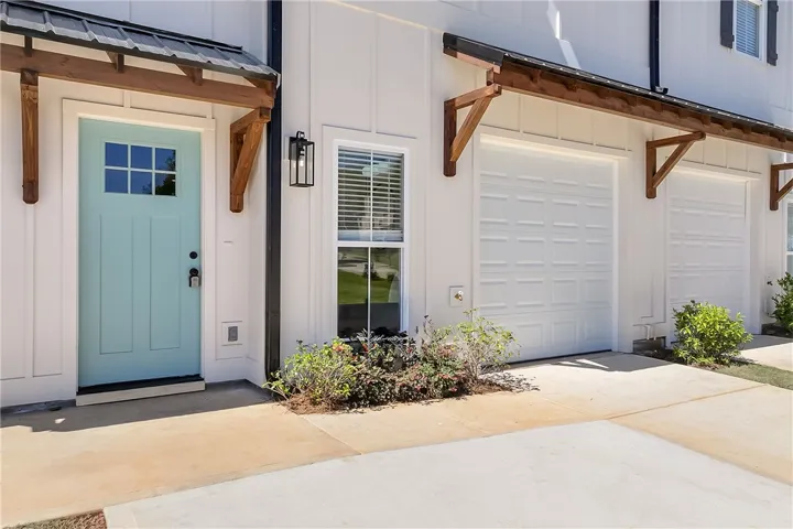 Sharp board and batten siding frames the inviting entry porch and single-car garage.