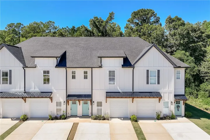 Crisp board and batten siding pairs beautifully with contrasting roofs on this modern multi-family exterior.
