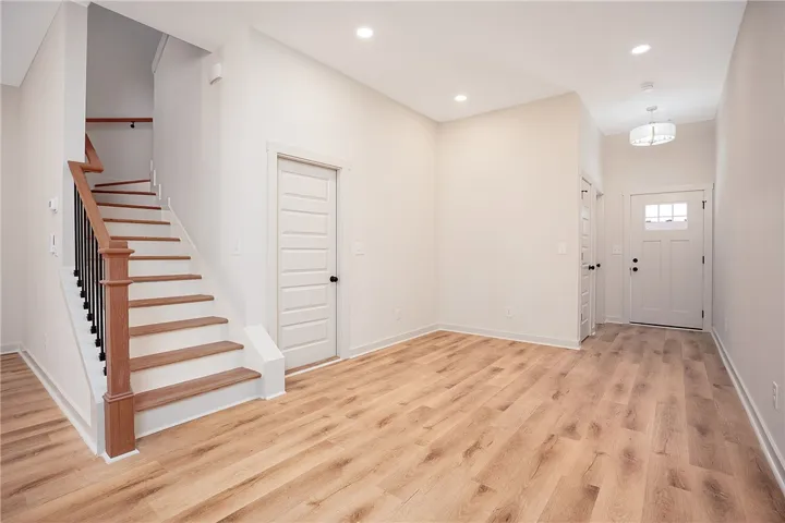 A welcoming entryway showcases handsome wood flooring and a classic staircase.