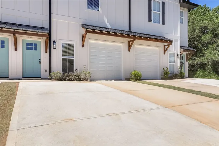 Board and batten siding pairs with metal awnings for modern architectural appeal.
