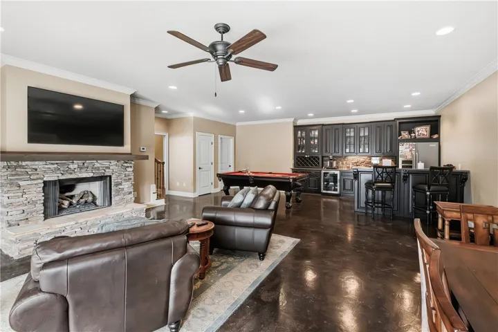 Downstairs living room with gas fireplace, kitchenette and high bar for seating