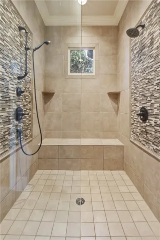 Primary shower with 2 shower heads and bench
