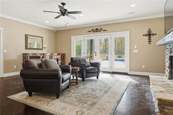 Downstairs living room with access to pool deck. Doors have alarm system for pool