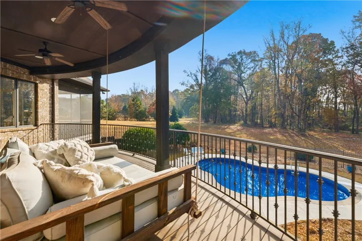 Deck with swinging bed overlooking pool