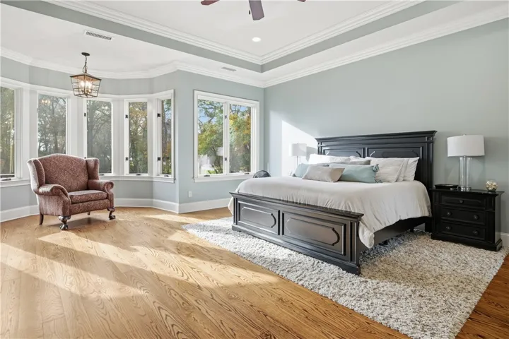Primary suite overlooking pool and backyard