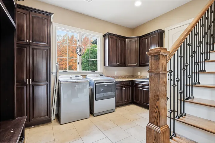 Laundry room with sink, cabinetry and drop zone off of garage