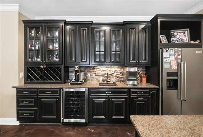 Downstairs kitchenette with wine cooler, sink and refrigerator