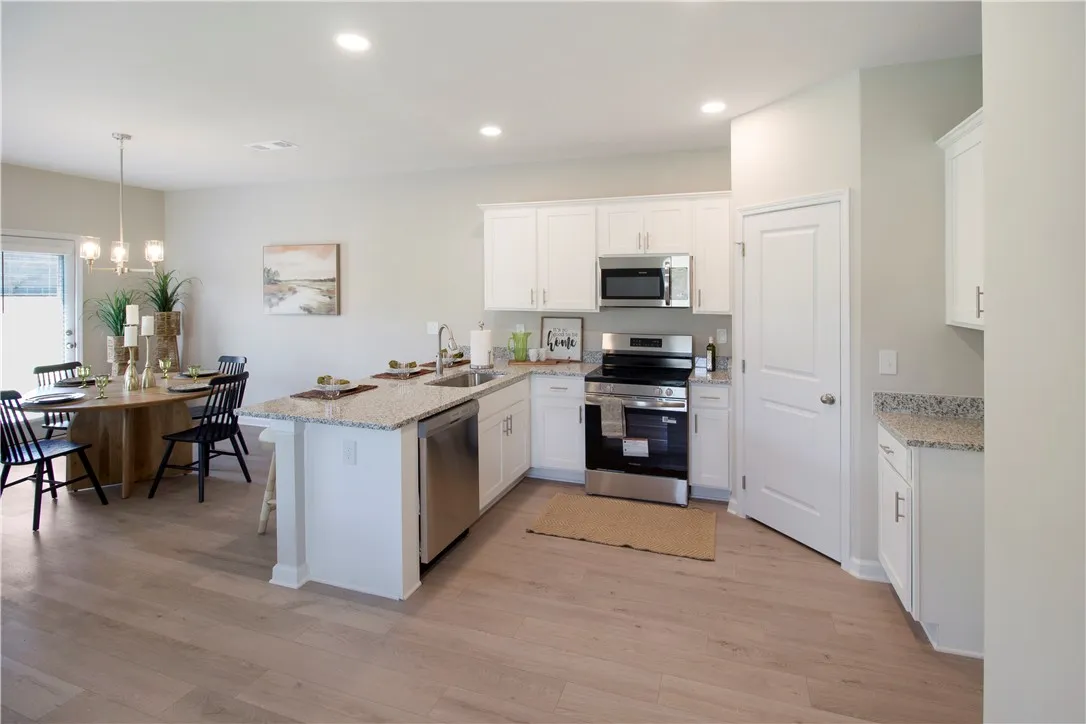 This bright kitchen features an open concept layout with contemporary finishes, perfect for modern living.