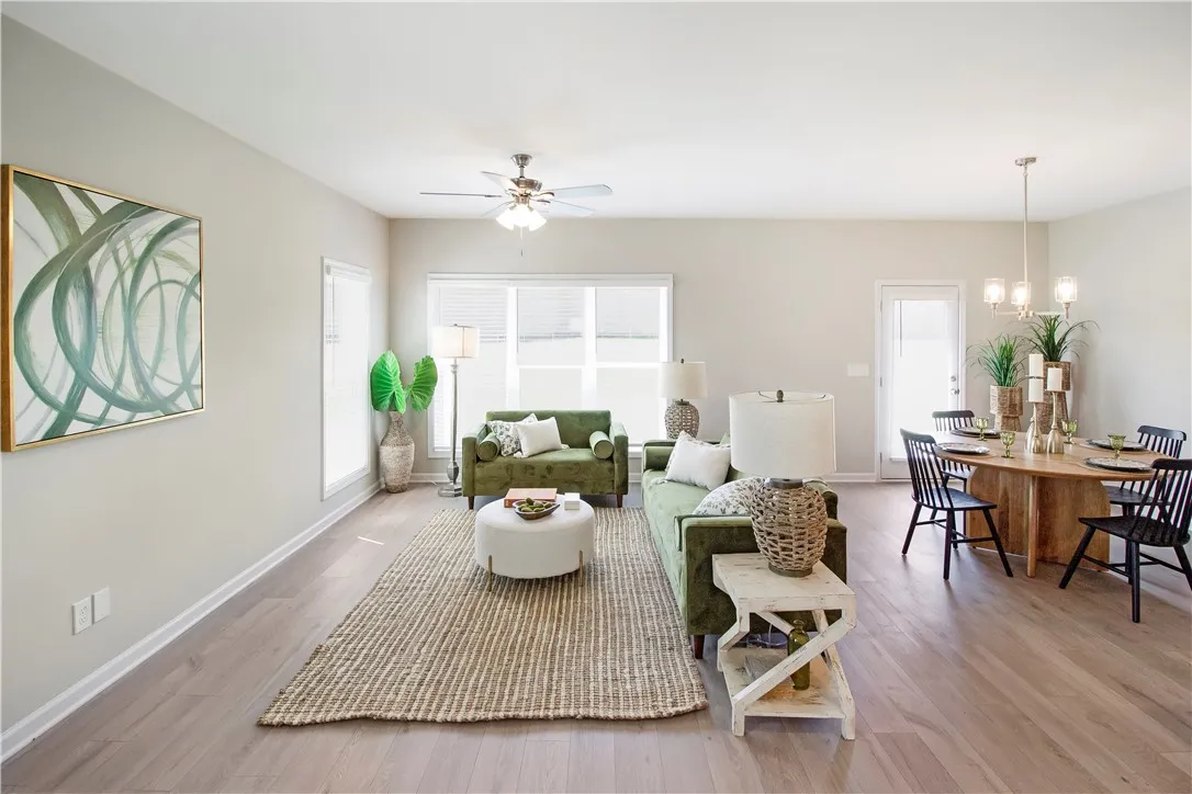 Bright and airy open-concept living and dining area with durable wood flooring.