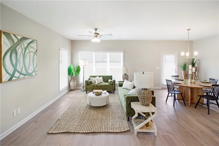 Bright and airy open-concept living and dining area with durable wood flooring.