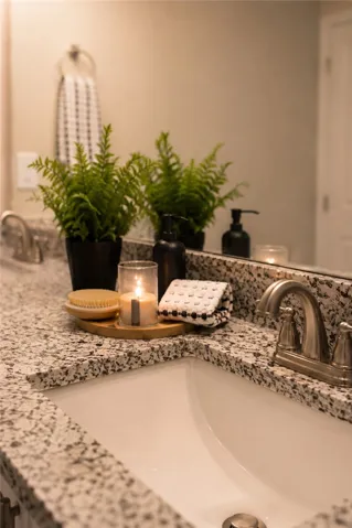 Granite counters and dual sinks provide ample space in this well-appointed primary bathroom.