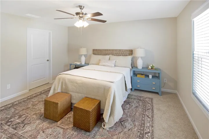 This inviting bedroom offers comfort and tranquility with ample natural light.