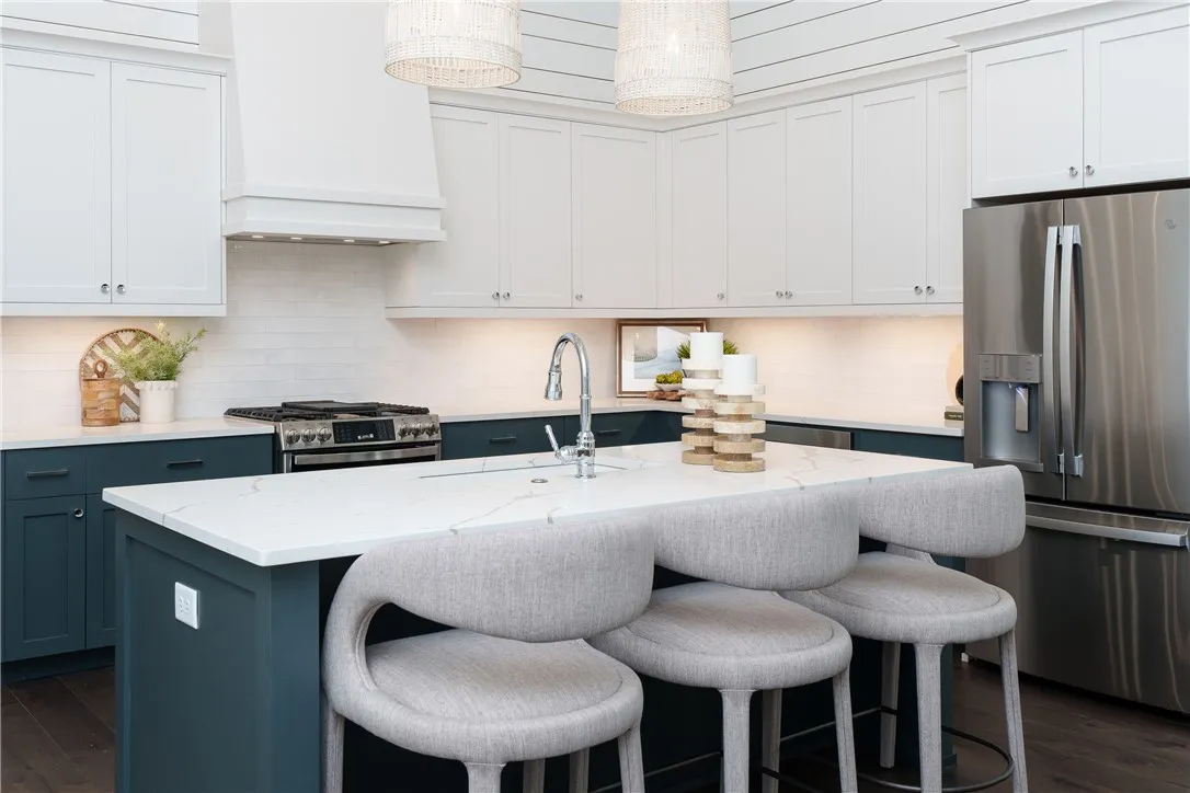 This kitchen features a bright, modern design with an inviting island, perfect for entertaining. (photo of previous sale)