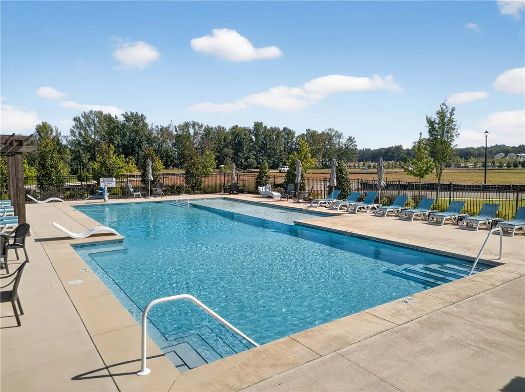 Relax and refresh by the expansive community pool, surrounded by serene natural views.