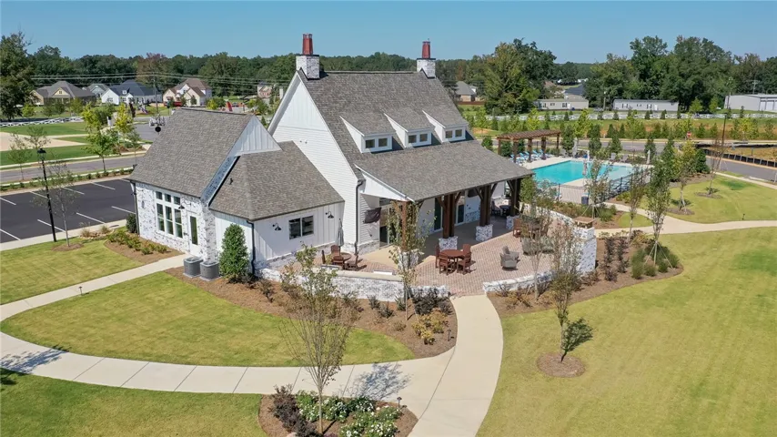 This charming community clubhouse features a welcoming patio and a refreshing pool, perfect for outdoor enjoyment.