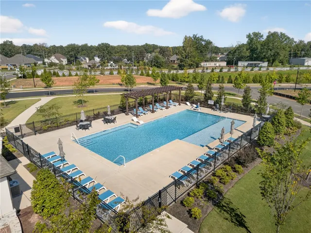 This inviting outdoor pool area offers relaxation and recreation for all residents.