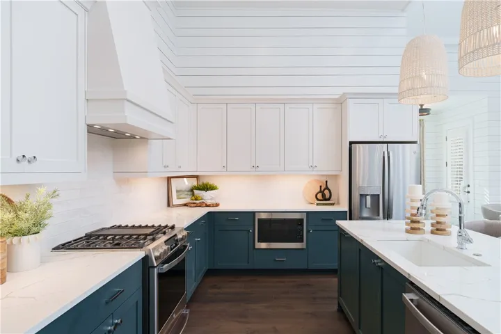 This modern kitchen features rich cabinetry, state-of-the-art appliances, and abundant counter space for daily living.