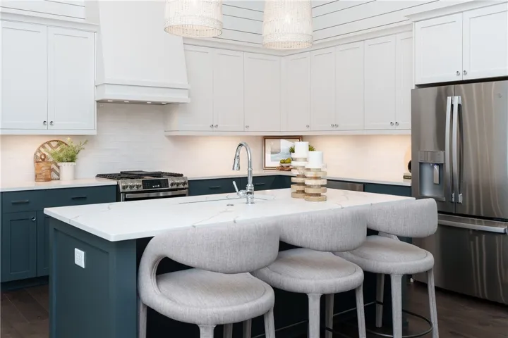 This kitchen features a bright, modern design with an inviting island, perfect for entertaining. (photo of previous sale)