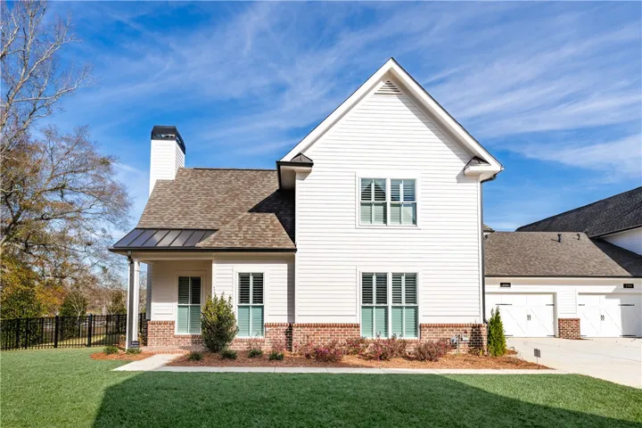This appealing dwelling showcases charming brick accents and a well-maintained lawn.