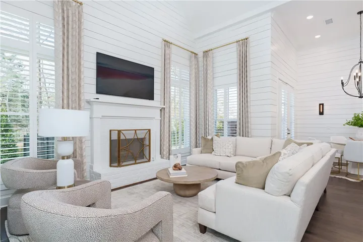 Bright and airy living area with a beautiful fireplace, perfect for relaxation and gatherings. (photo of previous sale)