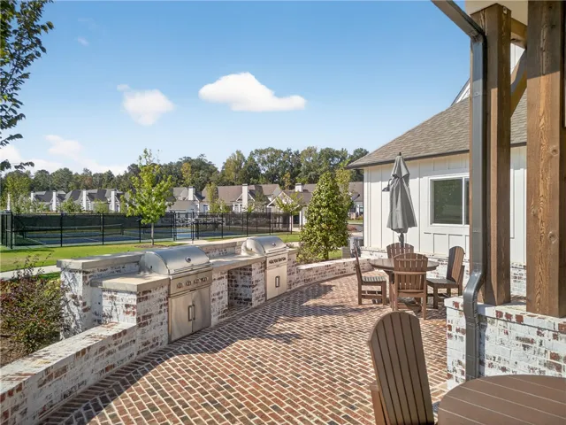 This inviting patio features an outdoor kitchen, perfect for entertaining guests under the open sky.