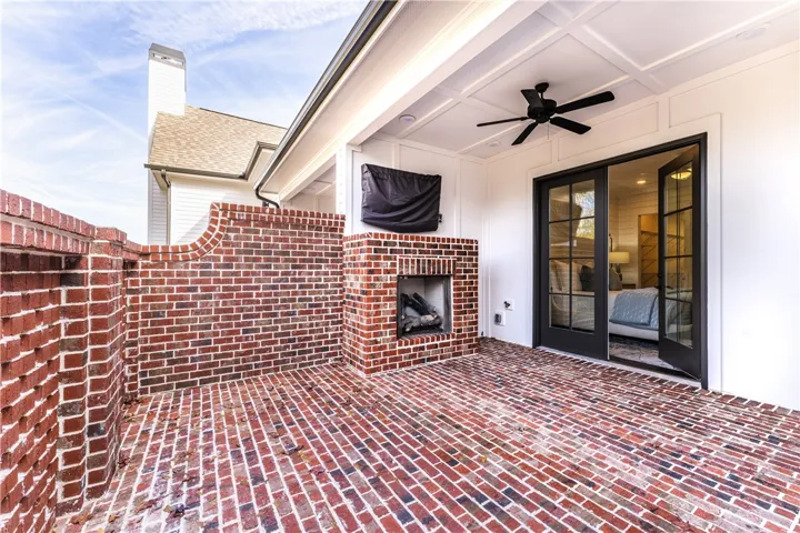 This inviting outdoor patio space features a fireplace and direct access to interior comfort. (photo of previous sale)