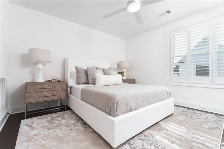 This serene bedroom offers comfort and style, featuring ample natural light and modern design. (photo of previous sale)