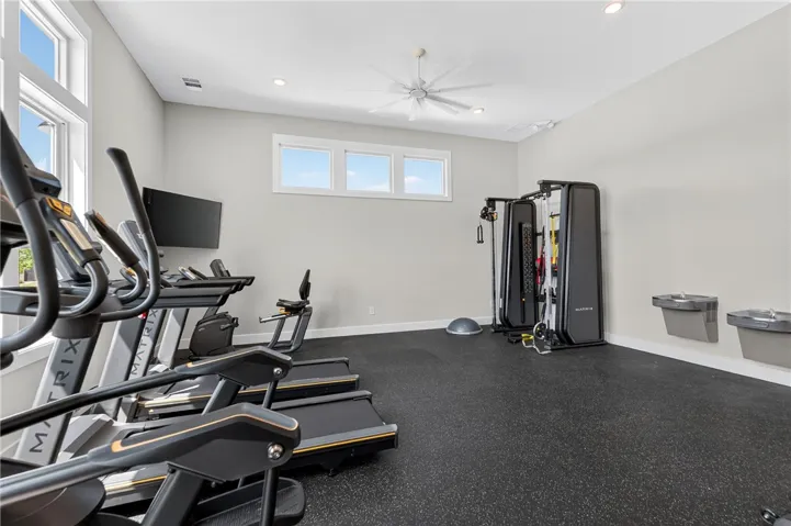 This dedicated fitness room features exercise equipment and bright windows, perfect for an active lifestyle.