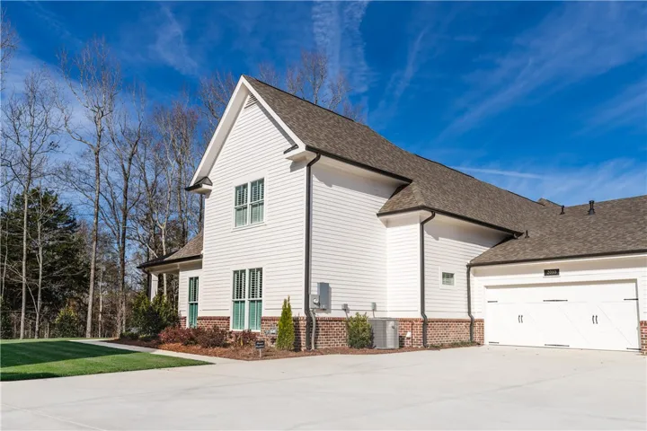 This newly built residence features clean lines, classic siding, and a spacious attached garage.