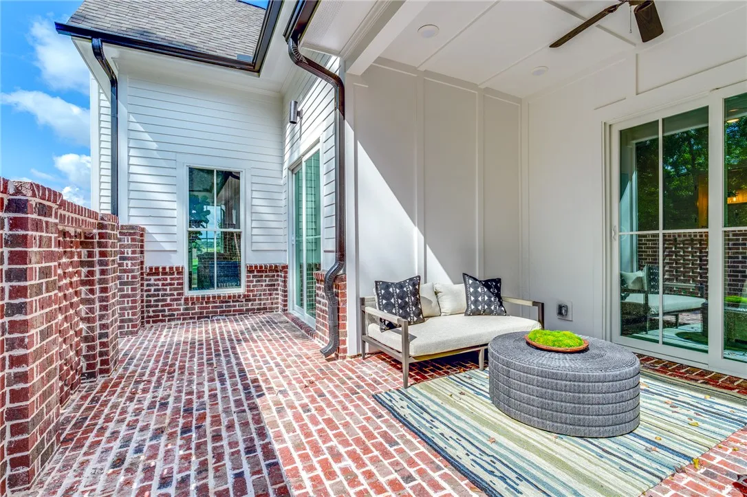 This inviting outdoor patio space features durable brick flooring and a cozy seating area.