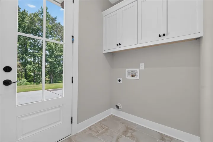 Laundry room with rear exit to driveway