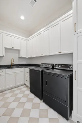 Ample storage and a dedicated sink combine in this well-appointed utility area.