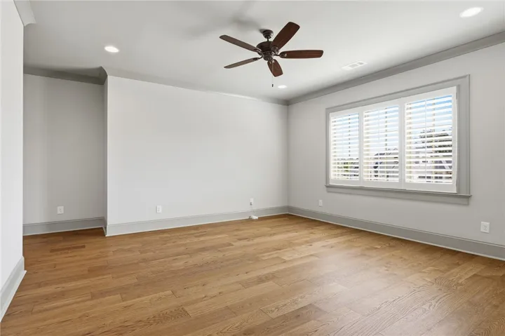 A well-proportioned room features rich hardwood flooring and abundant natural light.