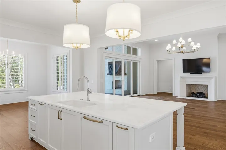 This Kitchen Is A Culinary Haven, Seamlessly Blending High-End Materials- Marble Countertops, Custom Cabinetry, & Professional Grade Appliances Create a Space That Is As Luxurious & Ideal For Entertaining As It Is Functional.