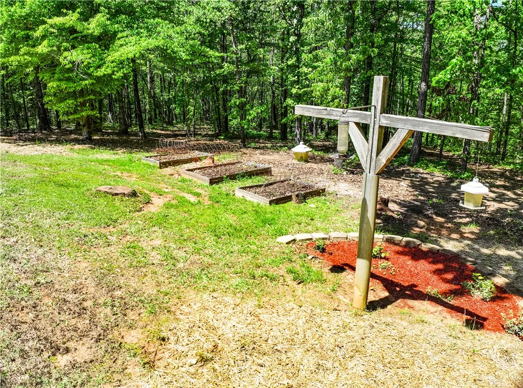 This tranquil yard features a dedicated garden space, offering a connection to nature and sustainable living.