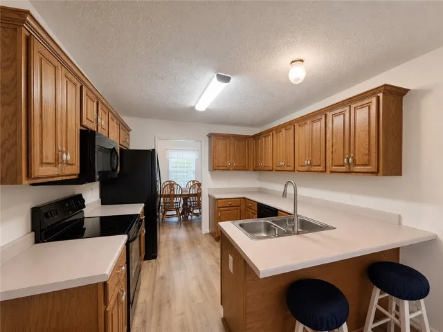 Functional kitchen with ample cabinetry and a convenient breakfast bar.