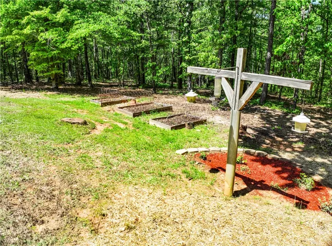 This tranquil yard features a dedicated garden space, offering a connection to nature and sustainable living.