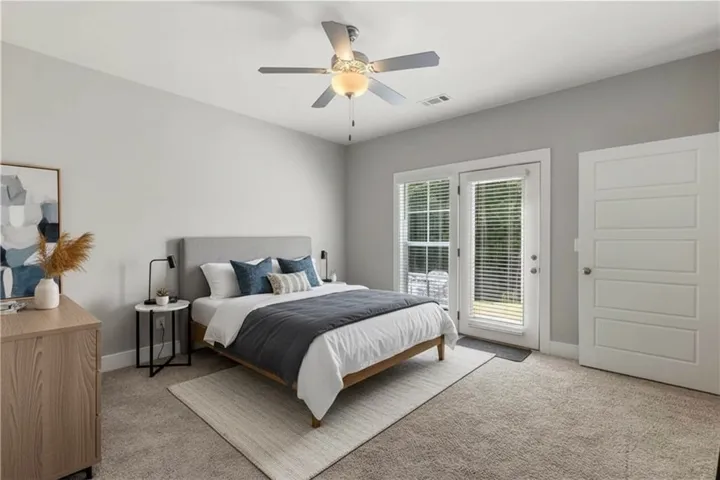 Plush carpet and French doors create a relaxing, quiet sanctuary. Virtually staged.