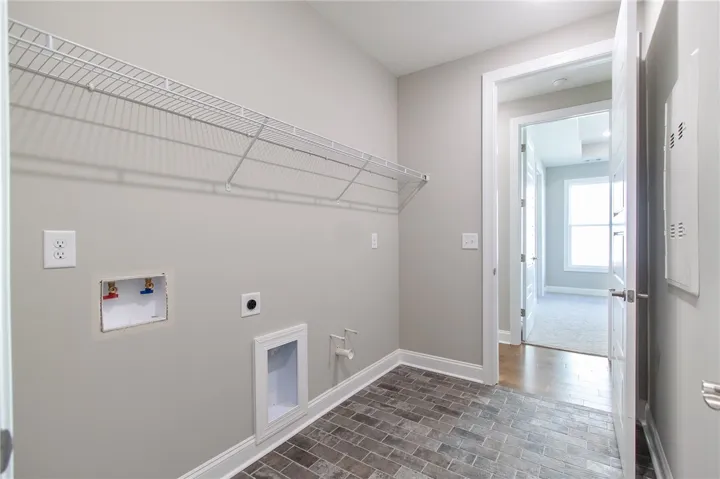 This dedicated utility space features convenient hookups and ample storage with wire shelving.