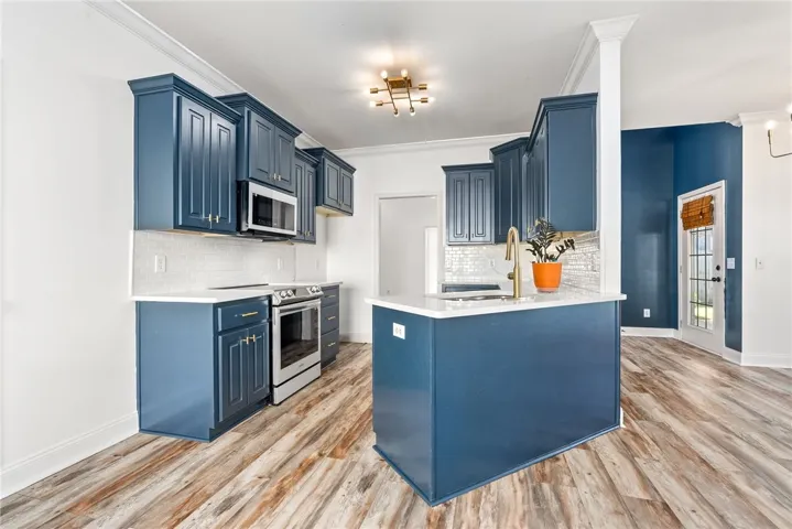 Updated kitchen with modern lighting, quartz countertops, subway backsplash and modern white glass appliances